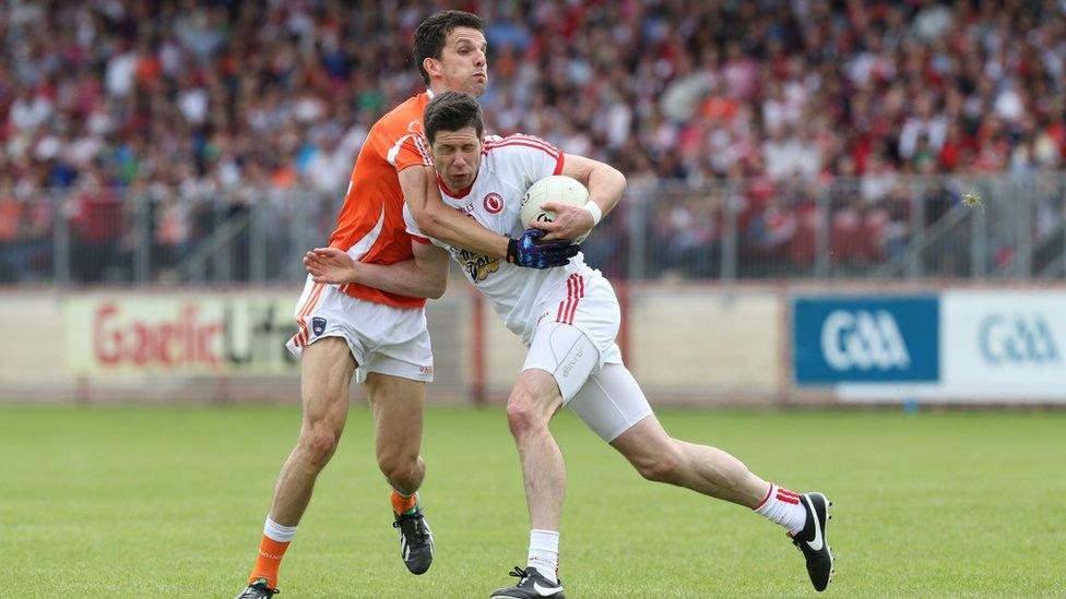 Stephen Harold of Armagh challenges Tyrone captain Sean Cavanagh