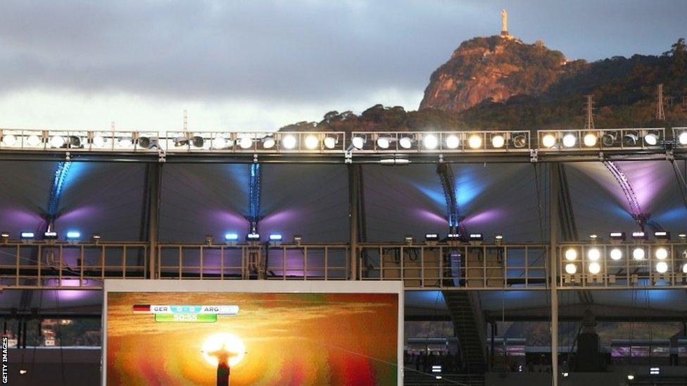 The sun shines on Christ The Redeemer statue in Rio