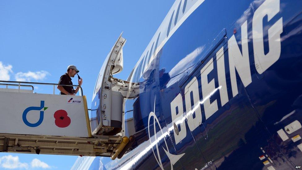 A man enters a Boeing B787-9 aircraft at the Farnborough air show in Hampshire