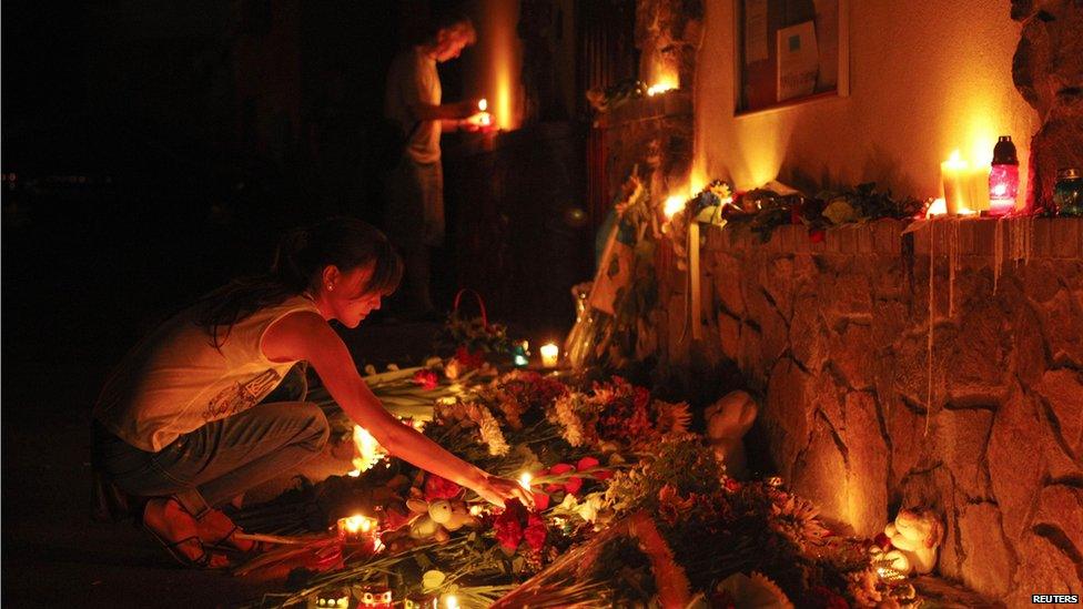 People light candles at the Malaysian embassy for victims of Malaysia Airlines MH17, which crashed in eastern Ukraine, in Kiev on 17 July 2014