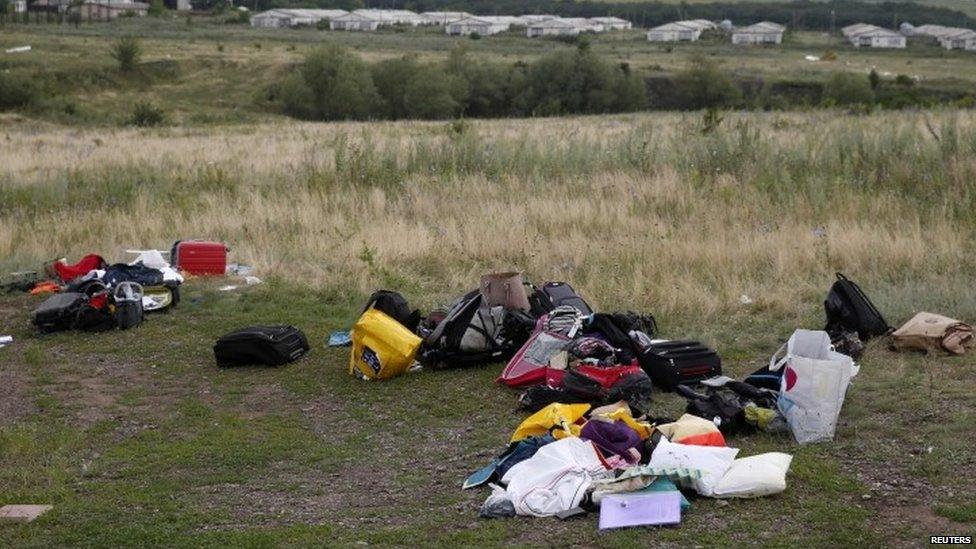 Luggage and belongings are seen near the site of Thursday's Malaysia Airlines Boeing 777 plane crash