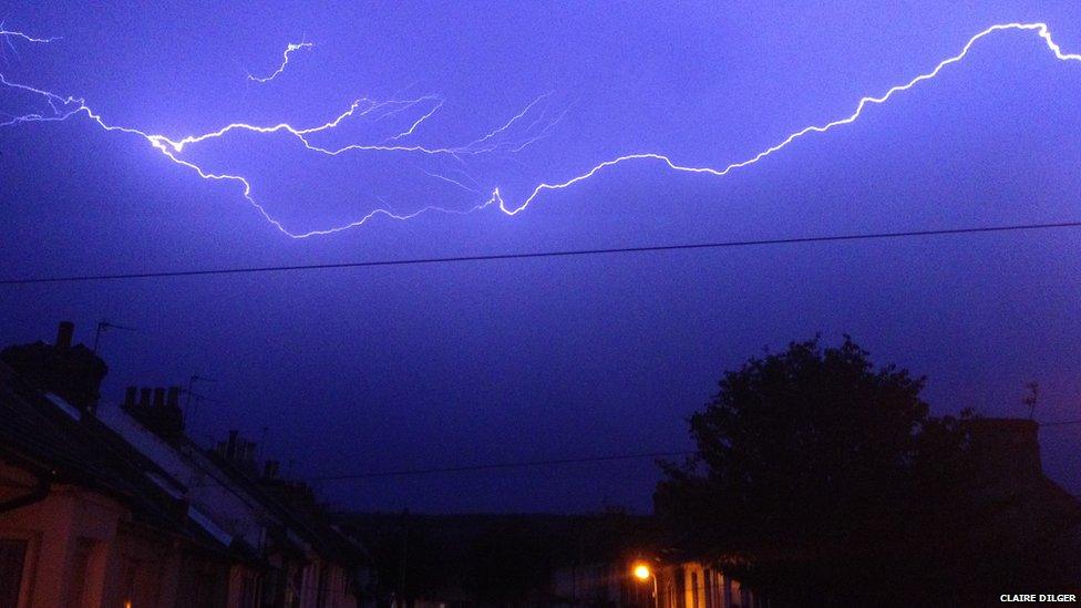 Lightning over rooftops.