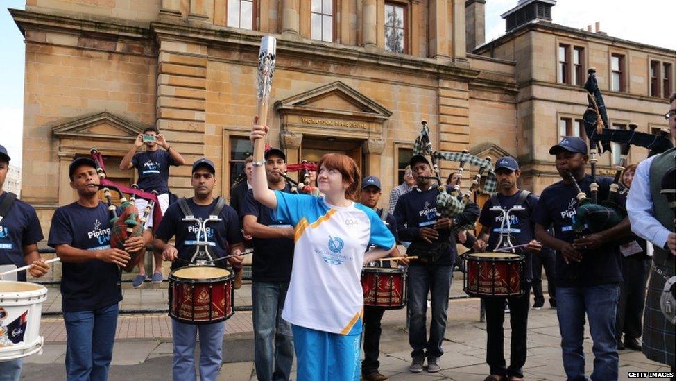 Batonbearer 034 Paula McGuire carries the Glasgow 2014 Queen"s Baton at the National Piping Centre