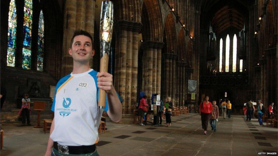 Batonbearer 052 Scott Maxwell carries the Glasgow 2014 Queen"s Baton at Glasgow Cathedral