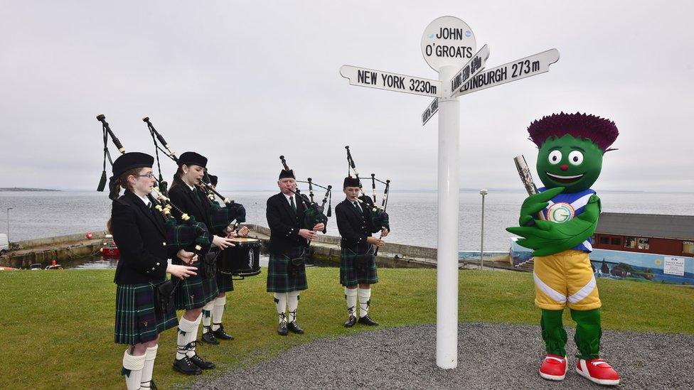 Clyde the the Glasgow 2014 Commonwealth Games mascot and members of the Wick Pipe Band welcome the Glasgow 2014 Queen's Baton to John O'Groats in the Scottish Highlands.