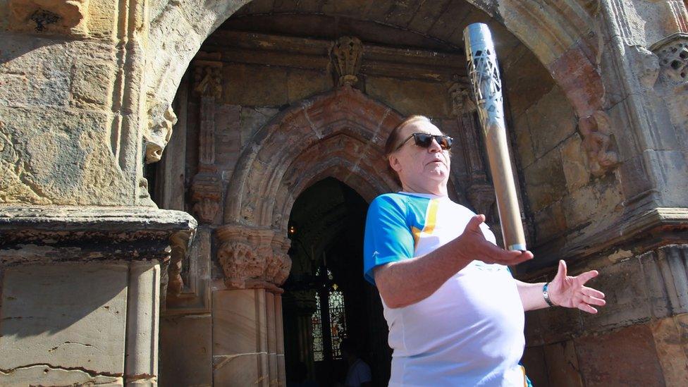 Actor Brian Cox carries the Queen's Baton at Rosslyn Chapel, Midlothian.