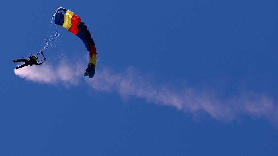 Baton bearer, Warrant Officer Class 1 Shane Cook, from the Royal Electrical & Mechanical Engineers (REME) Parachute Display Team, parachutes into Gleneagles golf course with the Glasgow 2014 Queen's Baton, in Perth & Kinross. T