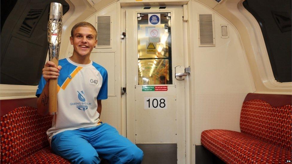 Batonbearer 043 Robin Galloway carries the Glasgow 2014 Queen"s Baton on the Glasgow Subway