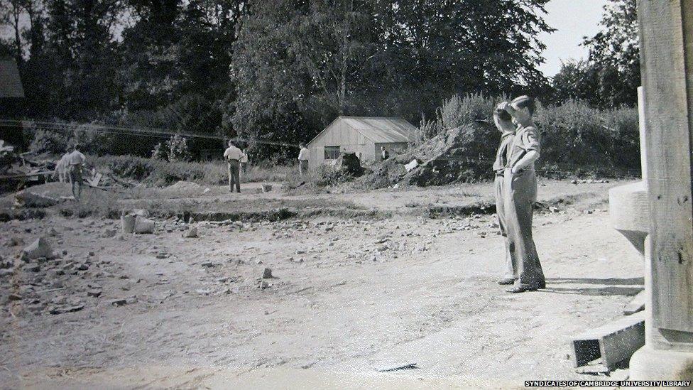 Workers play cricket on the building site of where the new library was being constructed