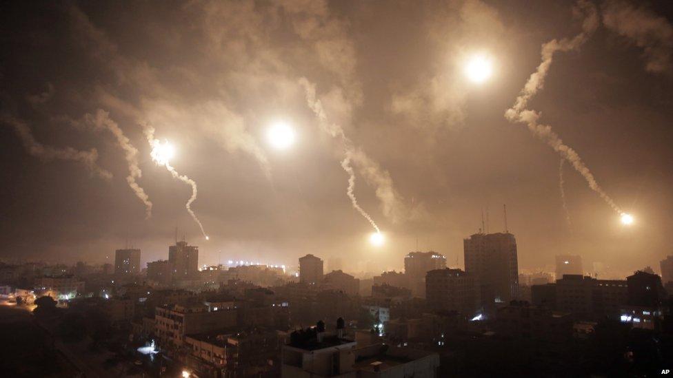 Israeli forces' flares light up the night sky of Gaza City early 29 July 2014.