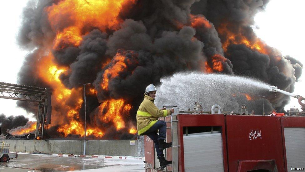 A Palestinian fire-fighter works during efforts to extinguish a fire at Gaza's main power plant, in the central Gaza Strip