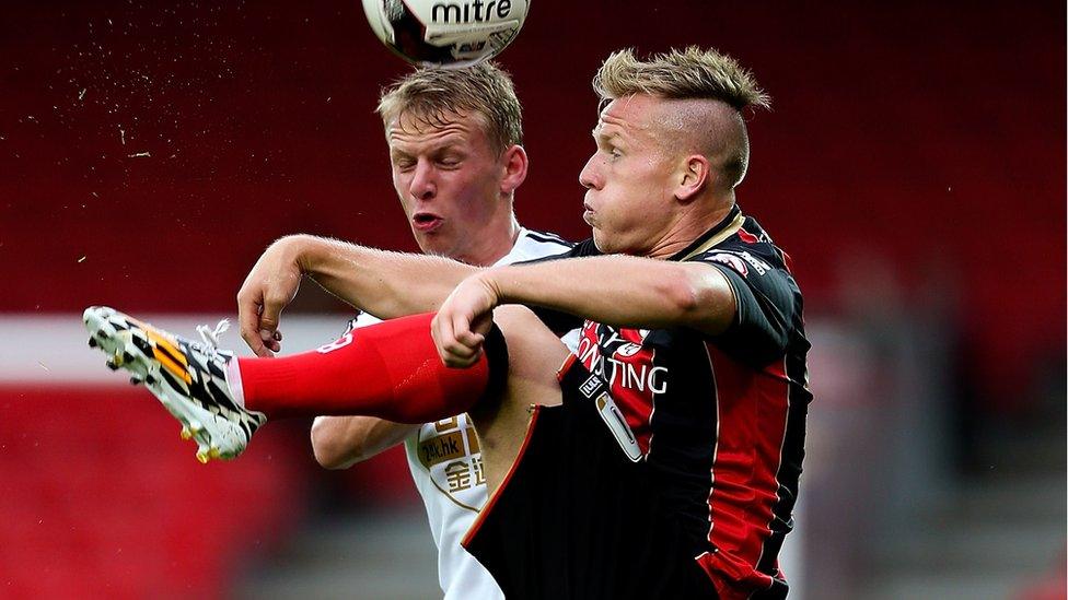 Matt Ritchie of Bournemouth holds off pressure from Stephen Kingsley of Swansea