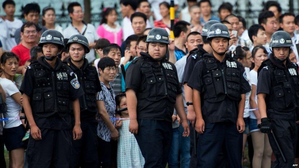 Policemen block the road next to a factory after an explosion in Kunshan, 2 Aug