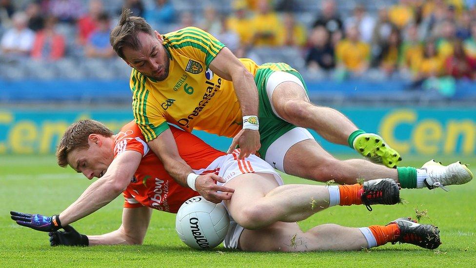 Armagh's Charlie Vernon and Karl Lacey of Donegal hit the deck in a battle for possession during the All-Ireland last-eight contest