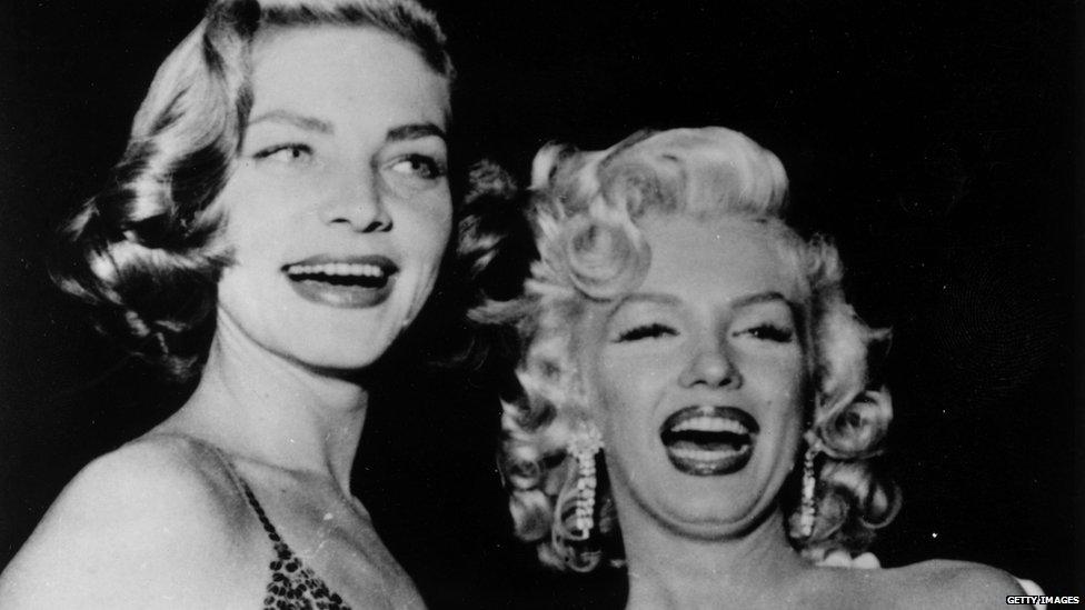 File photo: Film stars Lauren Bacall (left) and Marilyn Monroe, 4 March 1954
