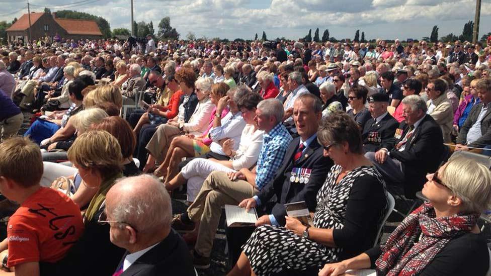 People gathered in front of the memorial