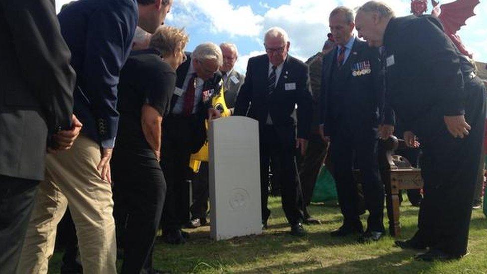 A white stone bearing the words of the Welsh national anthem is presented to the Welsh campaign committee