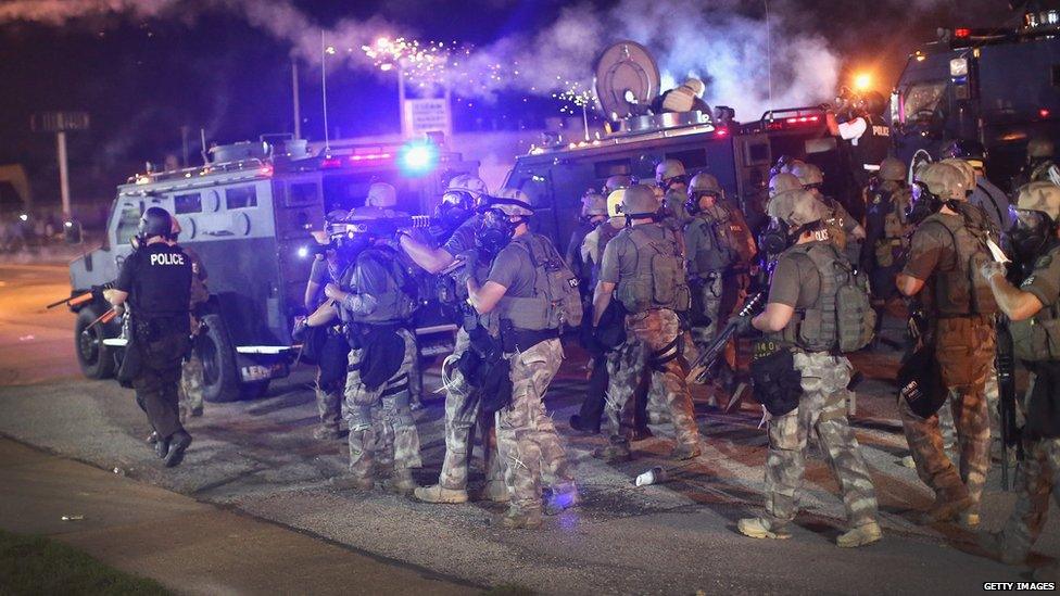 Police advance while sending a volley of tear gas toward demonstrators protesting the killing of teenager Michael Brown in Ferguson, Missouri, 17 August 2014