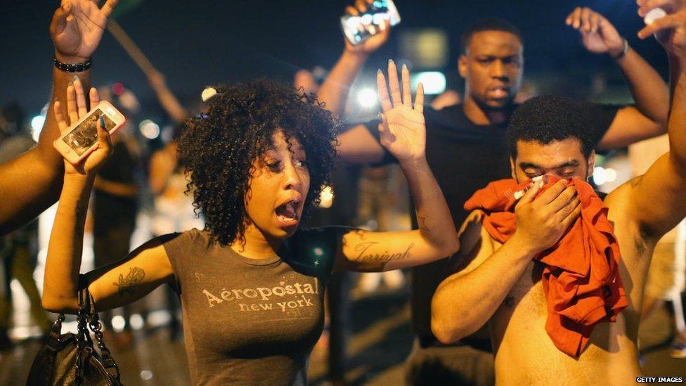 Protesters hold hands up in Missouri