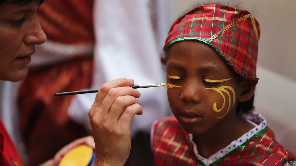 Girl getting her face painted for the carnival.