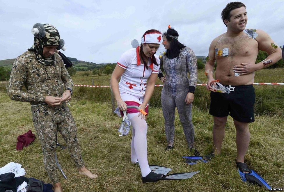 Llanwrtyd Wells bog snorkelling championships 2014 - competitors adjust their costumes