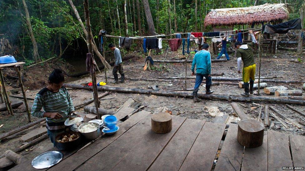 Families cook in a Camp built by illegal loggers in the Peruvian jungle, on the shores of the of the Esperanza river on 3 April 2013.