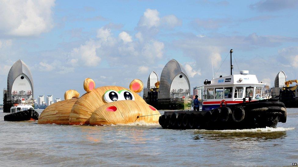 Giant hippo sculpture pulled by tug boats