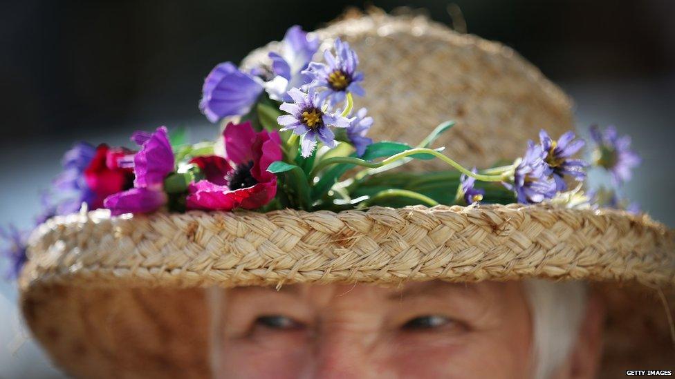 Exhibitor Penny Cunnington wears a floral display in her hat