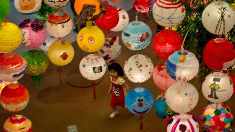 A Malaysian child plays amidst Chinese lanterns displayed at a mall ahead of the Mid-Autumn Festival celebrations in Kuala Lumpur on 7 September, 2014