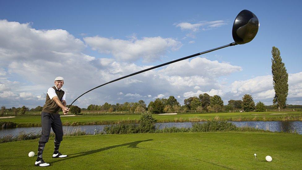 Man with giant golf club