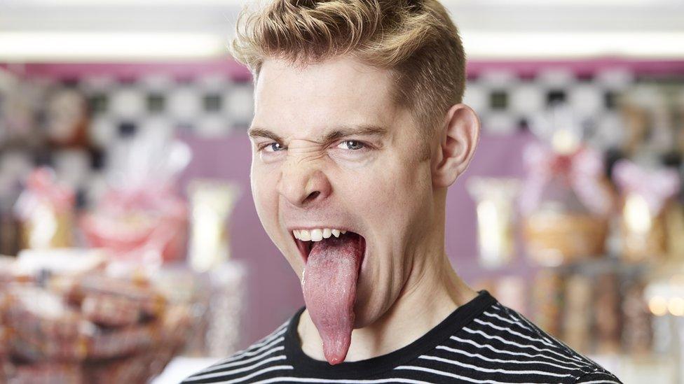 Man sticks out his long tongue