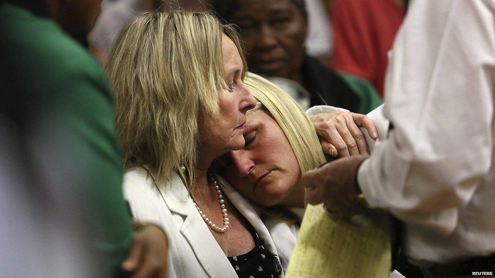 June Steenkamp (left), mother of Reeva Steenkamp, comforts her cousin Kim Martin during the verdict in the trial of Olympic and Paralympic track star Oscar Pistorius at the North Gauteng High Court in Pretoria, 12 September 2014