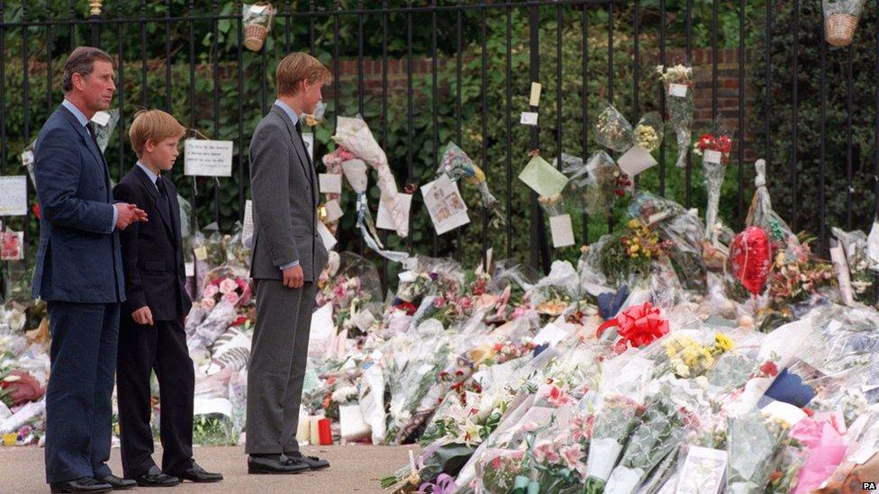 Prince of Wales and his sons Prince William and Prince Harry, view the sea of floral tributes to their mother, Diana, Princess of Wales, at Kensington Palace.