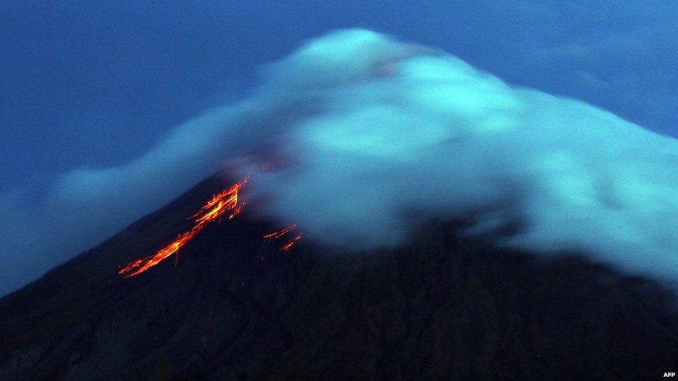 Lava flows from the crater of Mayon volcano seen from Legazpi City, Albay province, southeast of Manila on 17 September, 2014