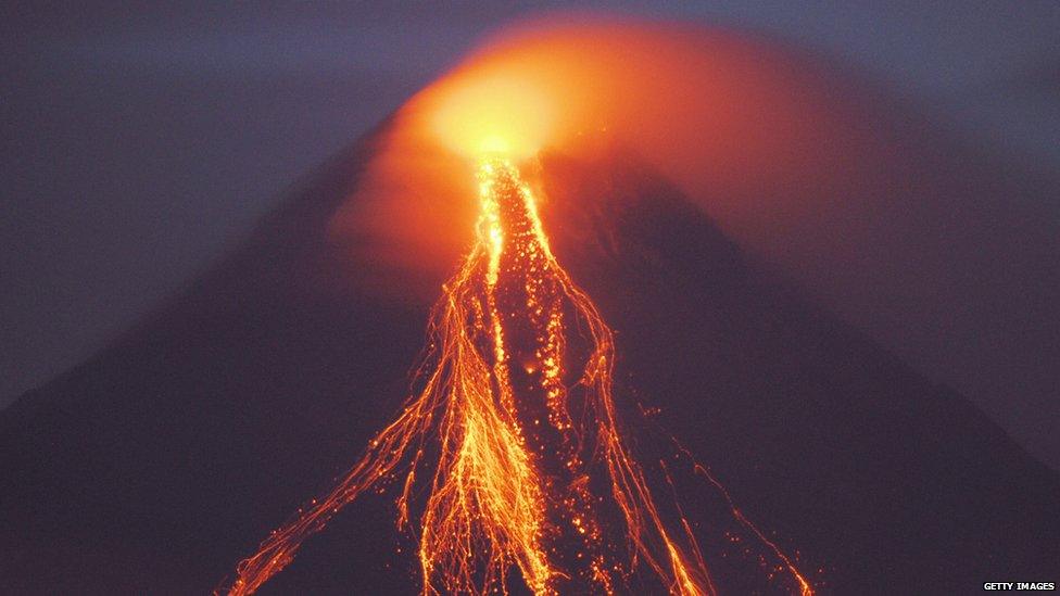 Lava flows from a crater of the restive Mayon volcano as seen from nearby city of Legazpi on 15 August 2006