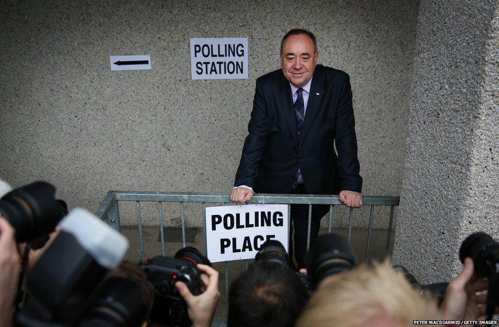 First Minister Alex Salmond stops for photographers as he casts his vote in the referendum in Strichen, Aberdeenshire