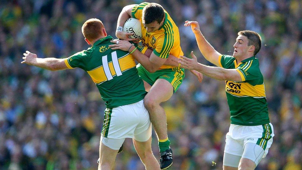 Kerry forward Johnny Buckley makes the block as Donegal's Leo McLoone takes the aerial route through