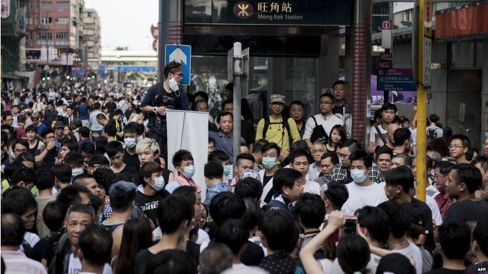 Protesters argue with a man (centre) opposing a pro-democracy demonstration as they block the Mong Kok MTR station exit next to Nathan Road, a major route through the heart of the Kowloon district of Hong Kong, on 29 September 2014.