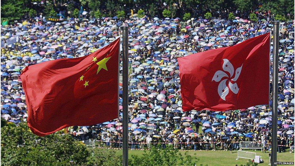 Chinese and Hong Kong flags over protests in Victoria Park, Hong Kong (1 July 2003)