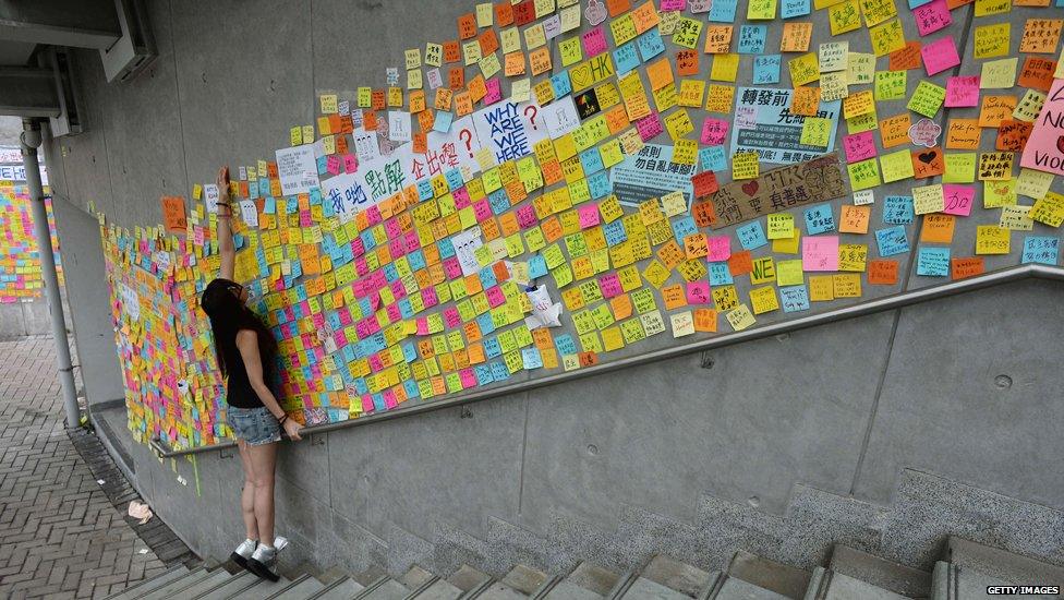 A young woman looks at messages of support