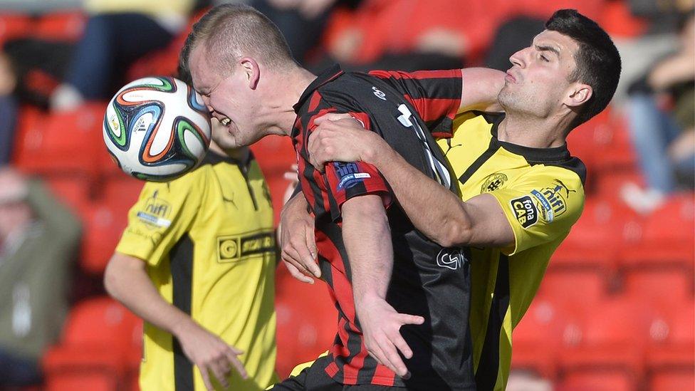 Crusaders striker Jordan Owens gets to the ball ahead of Cliftonville's Johnny Flynn