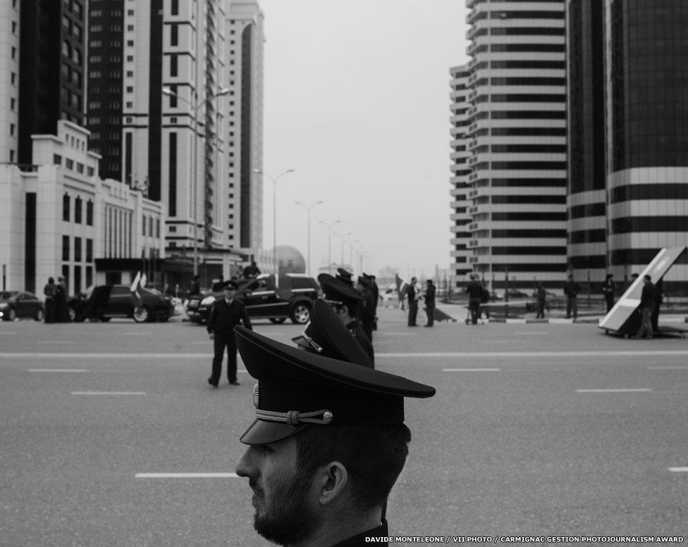 Security forces attending the 10th annual celebration of Constitution Day. In the background, the five gleaming Grozny-City Towers.