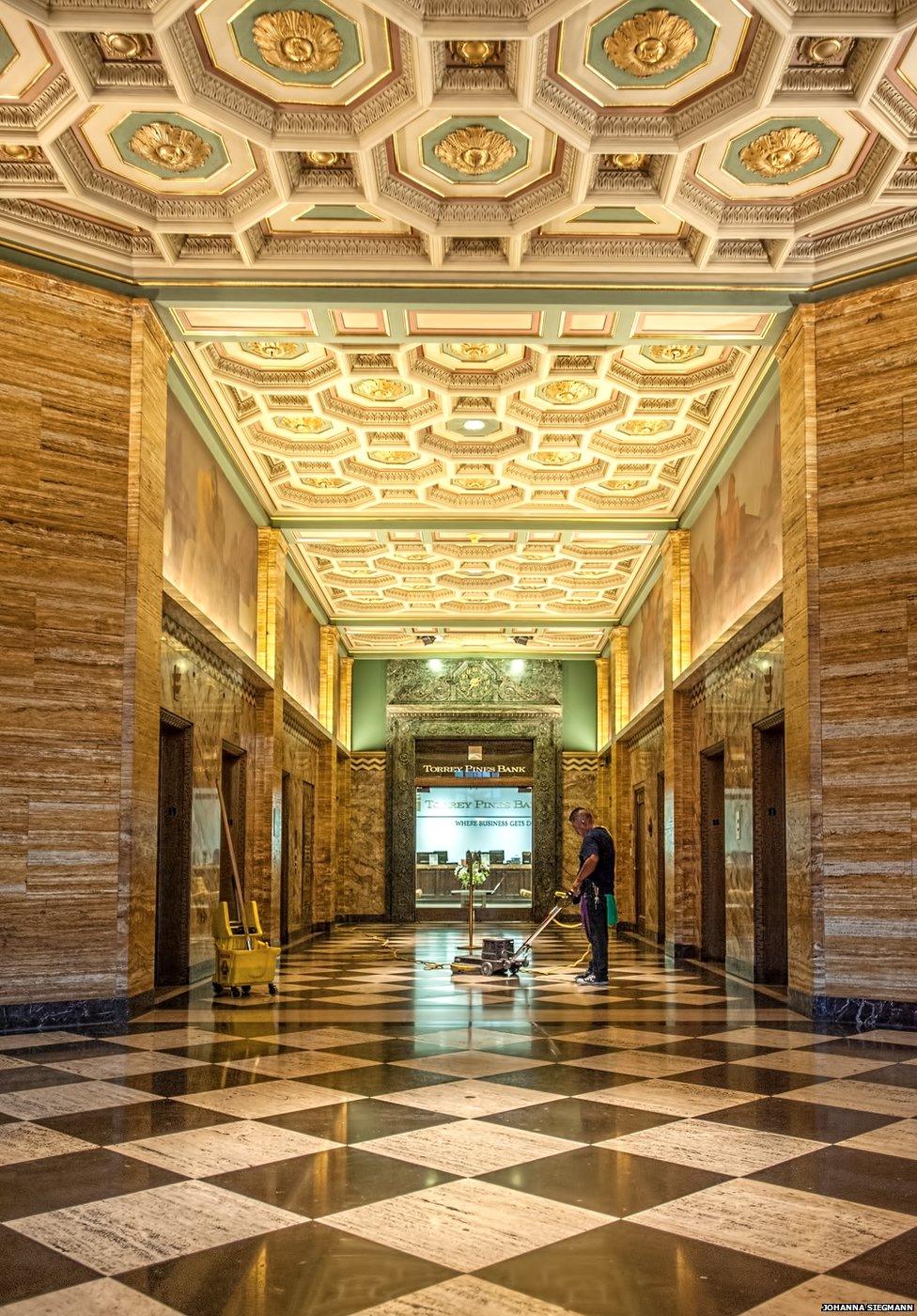 A man polishes the floor of a building