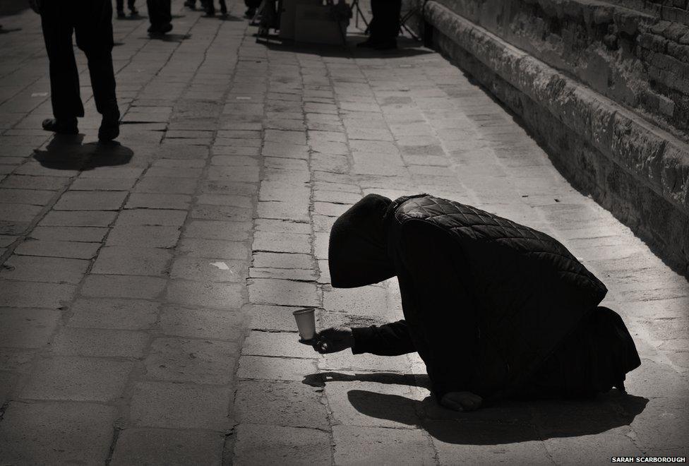 A person begging in the streets of Lisbon