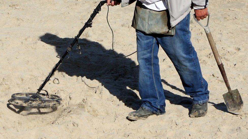 Metal detecting on a beach