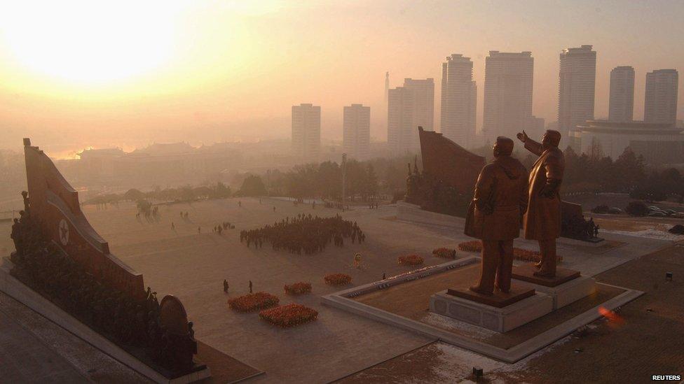 Statues of Kim Il-sung and Kim Jong-il against the Pyongyang skyline