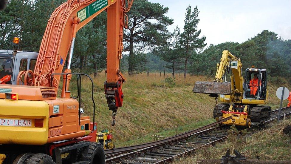 Cranes lifting the straight tracks