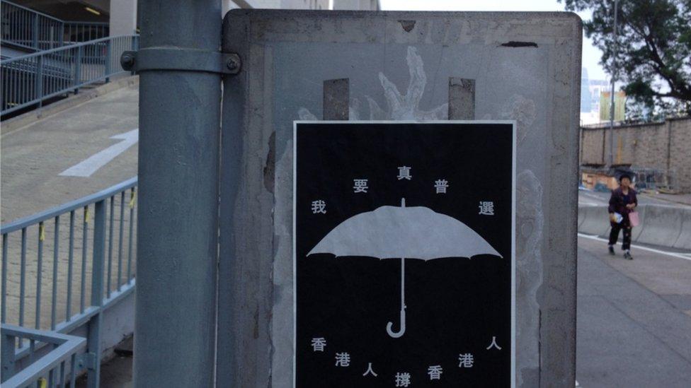 Street sign with umbrella