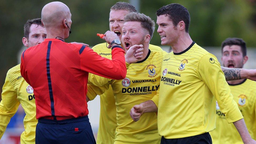 Dungannon Swifts players protest to referee Colin Burns after a penalty decision