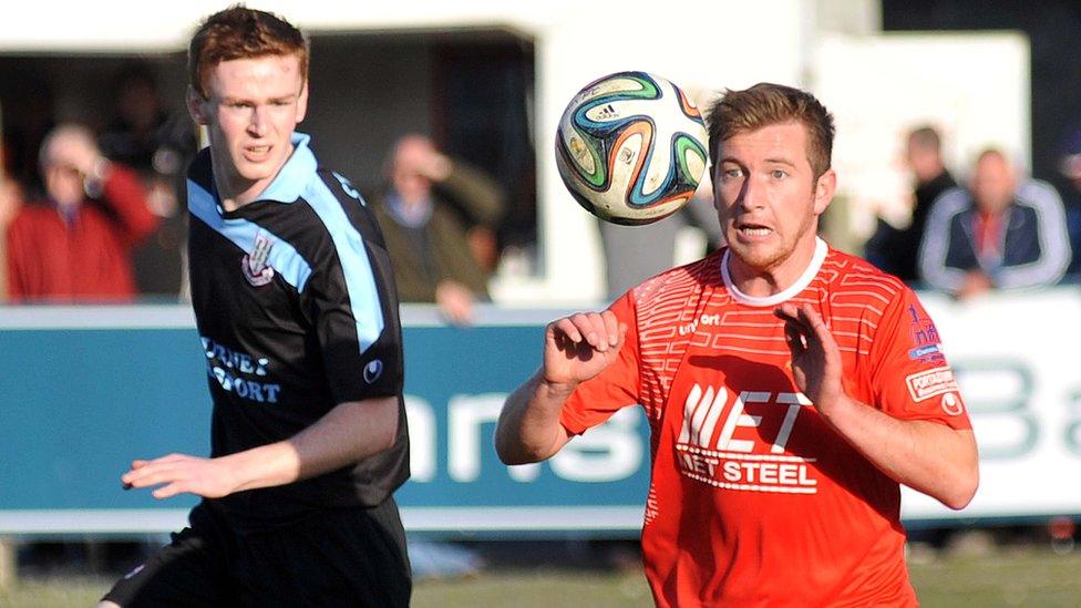 Aaron Stewart of Ballymena United in action against Portadown's Mark McAllister